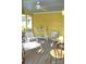 Bright yellow screened porch with seating area at 718 Ferndale Dr, Statesville, NC 28677