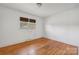 Bright bedroom with hardwood floors and two windows at 642 Fielding Rd, Charlotte, NC 28214