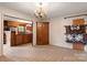 Dining room with views into kitchen, wood cabinetry and tile floor at 1573 Timberlake Dr, Shelby, NC 28150
