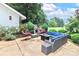 Outdoor patio with seating area, fire pit, and lush landscaping at 3208 Sedgefield Rd, Statesville, NC 28625