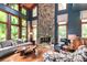 Living room with stone fireplace and large windows at 3208 Sedgefield Rd, Statesville, NC 28625