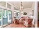Sunroom with terracotta tile floors, plaid sofa, and access to the backyard at 3208 Sedgefield Rd, Statesville, NC 28625