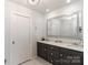 Modern bathroom with double vanity and a large mirror at 3208 Sedgefield Rd, Statesville, NC 28625