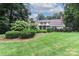 Spacious backyard with lush landscaping and a large grassy area at 3208 Sedgefield Rd, Statesville, NC 28625