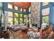 Living room with stone fireplace and wall-to-wall windows at 3208 Sedgefield Rd, Statesville, NC 28625