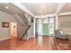 Spacious entryway with terracotta tile floors, a staircase, and views into the living room at 3208 Sedgefield Rd, Statesville, NC 28625