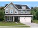 Two-story house with gray siding and stone accents at 315 Coronado Ave # 63, Matthews, NC 28104