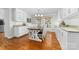 Bright kitchen with white cabinets, granite countertops, and a breakfast nook at 3029 River Rd, Shelby, NC 28152