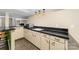 Basement kitchenette with dark countertops and light cabinets at 3029 River Rd, Shelby, NC 28152