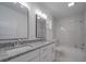 Bathroom boasts double vanity, marble shower, and white cabinets at 450 Cherry St, Wadesboro, NC 28170