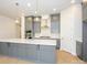 Modern kitchen with gray cabinets, white countertops, and gold accents at 1204 Meander Ln, Waxhaw, NC 28173