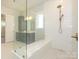 Walk in shower with white tile and built in bench at 1204 Meander Ln, Waxhaw, NC 28173