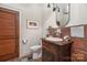 Charming bathroom with brick feature wall, antique vanity, and terracotta tile floor at 5403 Gorham Dr, Charlotte, NC 28226