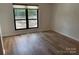 Bright bedroom with wood-look floors and large window at 7201 Winery Ln, Charlotte, NC 28227