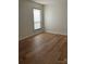 Well-lit bedroom featuring hardwood floors and a window at 7201 Winery Ln, Charlotte, NC 28227