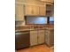 Modern kitchen features stainless steel dishwasher and updated teal cabinets at 7201 Winery Ln, Charlotte, NC 28227