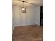 Simple dining room with wood-look floors and modern light fixture at 7201 Winery Ln, Charlotte, NC 28227