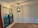 Dining area with hardwood floors and modern light fixture at 7201 Winery Ln, Charlotte, NC 28227