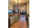Updated kitchen with light teal cabinets, stainless steel appliances, and wood-look floors at 7201 Winery Ln, Charlotte, NC 28227