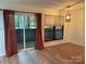 Dining area with hardwood floors, sliding glass doors, and red curtains at 7201 Winery Ln, Charlotte, NC 28227