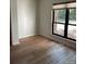 Spacious bedroom with wood-look floors and large window at 7201 Winery Ln, Charlotte, NC 28227