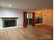 Living room with fireplace, hardwood floors, and sliding glass doors at 7201 Winery Ln, Charlotte, NC 28227