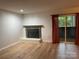 Living room with fireplace, hardwood floors, and sliding glass doors at 7201 Winery Ln, Charlotte, NC 28227