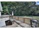 Relaxing back deck with seating area, fire pit table, and wooded backdrop at 1020 Saint Paul Church Rd, Clover, SC 29710