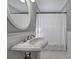 Clean bathroom with a pedestal sink, shower, and white patterned curtain at 1020 Saint Paul Church Rd, Clover, SC 29710