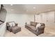 Finished basement offering a relaxing sitting area with couches and a large TV at 14941 Deer Hollow Dr, Gold Hill, NC 28071