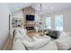 Bright living room showcasing a stone fireplace and built-in shelving at 14941 Deer Hollow Dr, Gold Hill, NC 28071