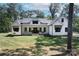 Modern farmhouse with white exterior, stone accents, and a welcoming front porch at 14941 Deer Hollow Dr, Gold Hill, NC 28071