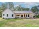 White farmhouse exterior with covered porch and large backyard at 14941 Deer Hollow Dr, Gold Hill, NC 28071