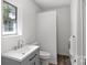 Updated bathroom with a gray vanity, white toilet, and a shower stall at 2009 Echo Ln, Gastonia, NC 28052