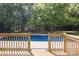 Deck overlooks a refreshing blue pool, surrounded by lush trees at 2009 Echo Ln, Gastonia, NC 28052