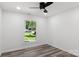 Bright bedroom with ceiling fan, wood-look floors, and a large window at 2009 Echo Ln, Gastonia, NC 28052