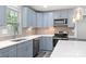 Modern kitchen with blue cabinets, stainless steel appliances, and quartz countertops at 2009 Echo Ln, Gastonia, NC 28052