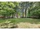 Large backyard with lush trees and grassy area at 2009 Echo Ln, Gastonia, NC 28052