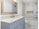 Modern bathroom with gray vanity, marble shower, and soaking tub at 2009 Echo Ln, Gastonia, NC 28052