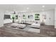 Living room with L-shaped sofa, hardwood floors, and large windows at 2009 Echo Ln, Gastonia, NC 28052
