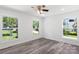 Well-lit bedroom with wood-look floors and multiple windows at 2009 Echo Ln, Gastonia, NC 28052