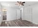 Bedroom with wood-look floors, ceiling fan, and built-in closet at 2009 Echo Ln, Gastonia, NC 28052