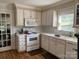 Kitchen with white cabinets, appliances, and hardwood floors at 331 Polk Ford Rd, Stanfield, NC 28163