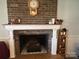 Brick fireplace with a mantel and decorative clock at 331 Polk Ford Rd, Stanfield, NC 28163