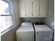 Laundry room with washer, dryer, and upper cabinets at 331 Polk Ford Rd, Stanfield, NC 28163