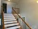 Elegant staircase with wooden railings and neutral walls at 331 Polk Ford Rd, Stanfield, NC 28163