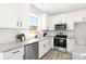 Modern kitchen with white cabinets, granite countertops, and stainless steel appliances at 294 Washington St, York, SC 29745