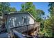 House exterior showcasing wooden deck and access to the backyard at 219 Rustic Hills Cir, Bessemer City, NC 28016