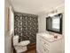 Clean bathroom with a floral shower curtain, white vanity, and updated fixtures at 7514 Secrest Shortcut Rd, Indian Trail, NC 28079