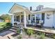 Inviting front porch with stone patio, fountain, and comfortable seating at 7514 Secrest Shortcut Rd, Indian Trail, NC 28079